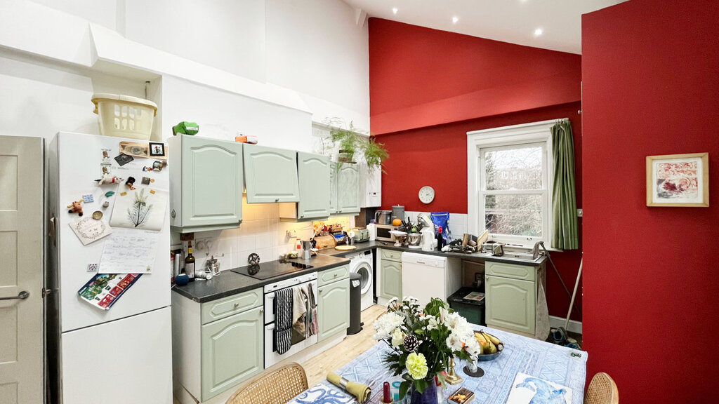 Spacious kitchen and dining area with very high ceiling.
