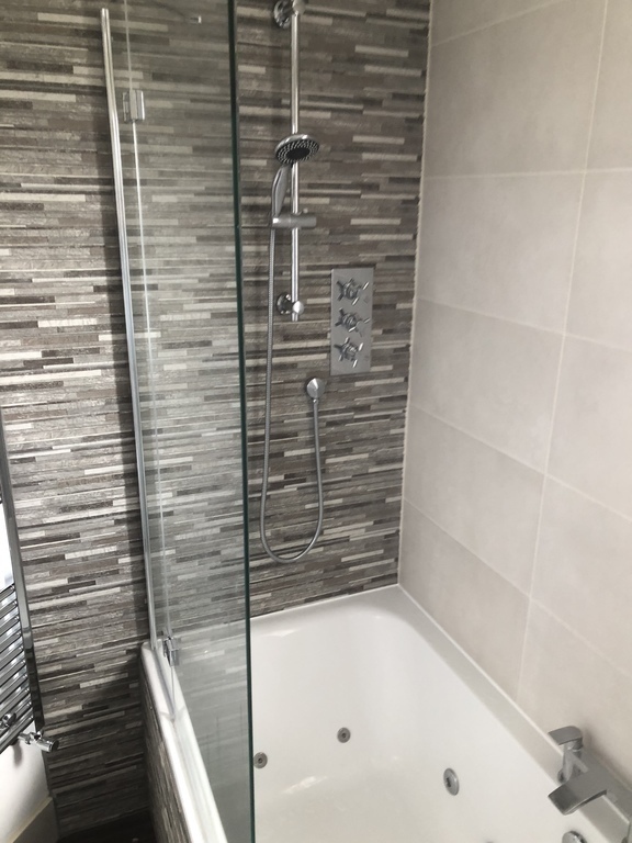 New bathroom with waterfall shower and double ended whirlpool bath