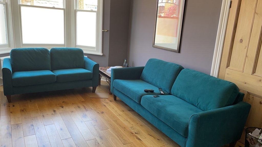 Teal velvet sofas in the living room
