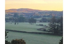 outside space at the back of the house overlooking the fields, hills and river