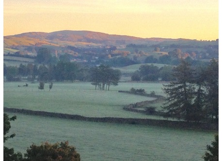 outside space at the back of the house overlooking the fields, hills and river