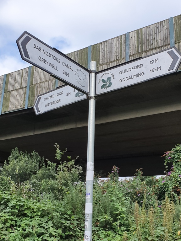 Signage at the junction of the local canal towpaths and the M25 motorway