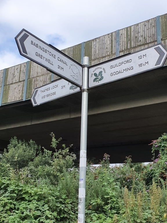 Signage at the junction of the local canal towpaths and the M25 motorway