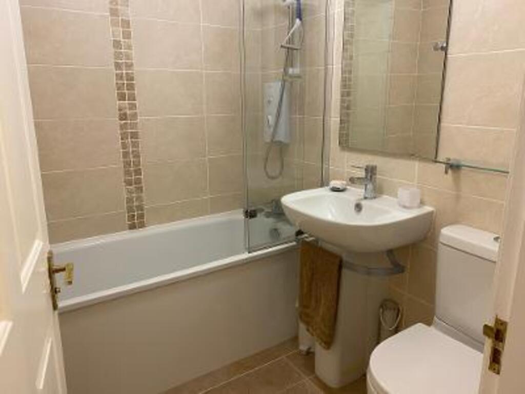Family bathroom with electric shower over bath