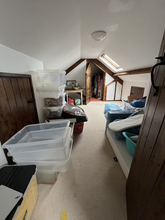 Attic main room with store room at back. This big room can be cleared and set up with a double mattress of the floor.