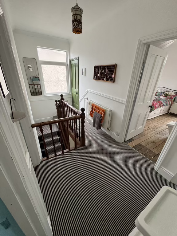 The hall. See green door to attic floor. 