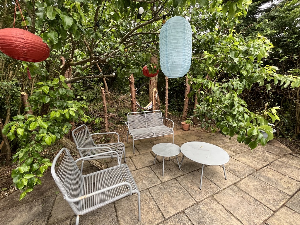 Back of garden - just chopped down hedge, usually can see stream behind from the seats. 