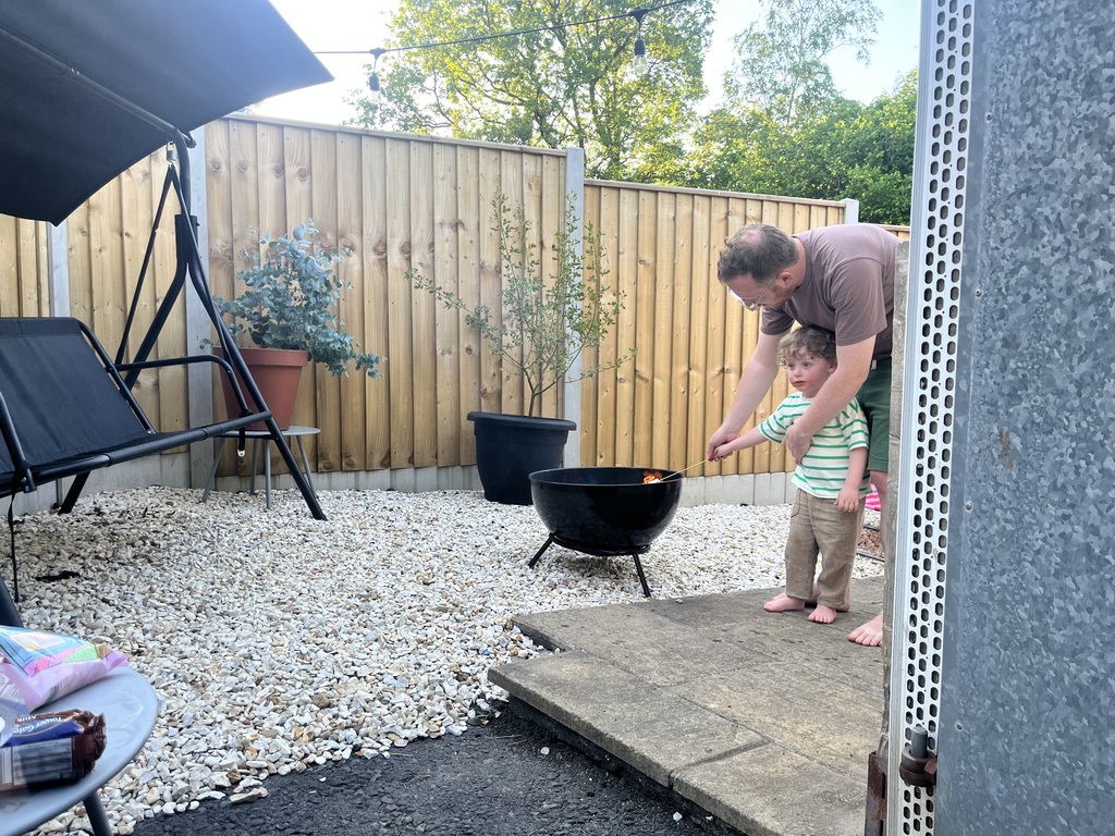 fire pit with plenty of wood in the shed