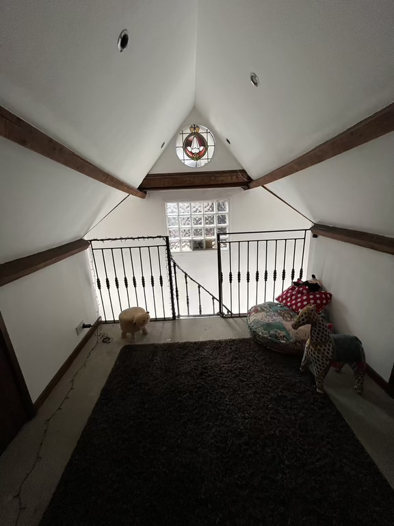 Mezzanine - stained window is internal into attic office. Not decorated the mezzanine yet. Space for numerous air mattresses.