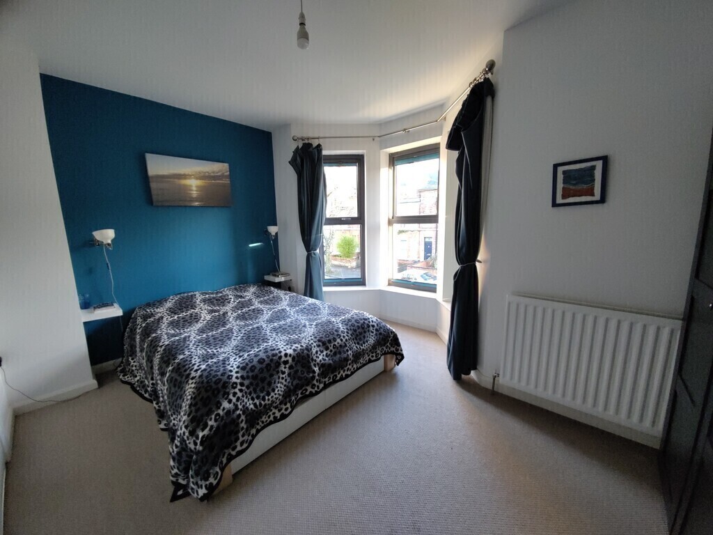 Main bedroom with a view onto the leafy street - very bright on sunny days 