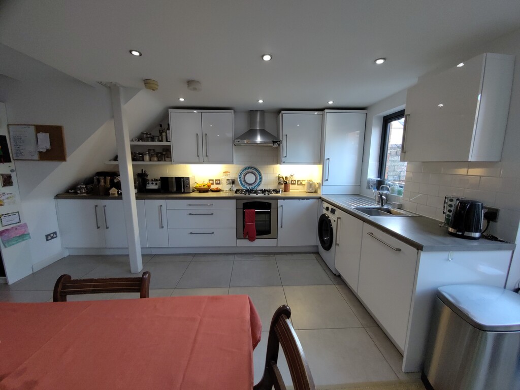 The kitchen area, with dishwasher, washing machine, electric oven and gas hob