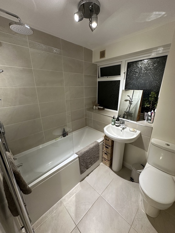 Bathroom with rainhead shower and bath