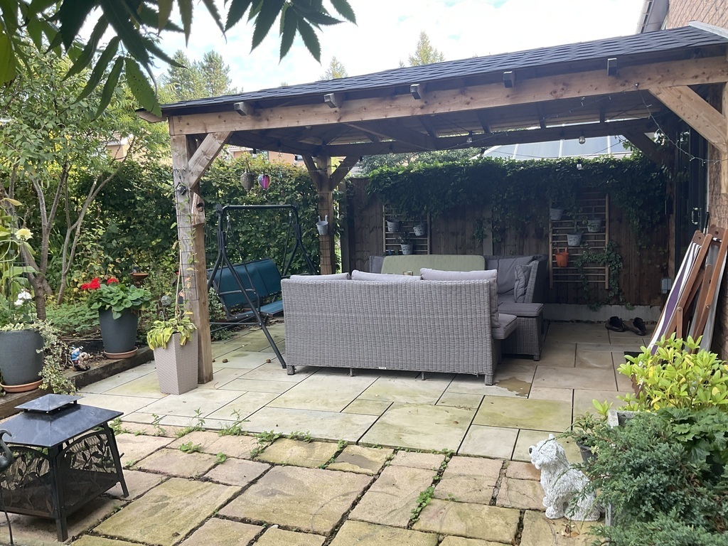 Comfortable, sheltered seating under a wooden gazebo