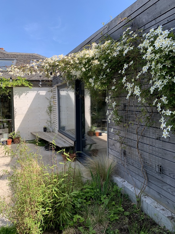 Back of the house. Garden patio area. Access to both the kitchen and the garden room. 
