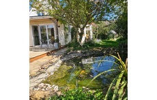 View from the side of the pond to the kitchen verandah