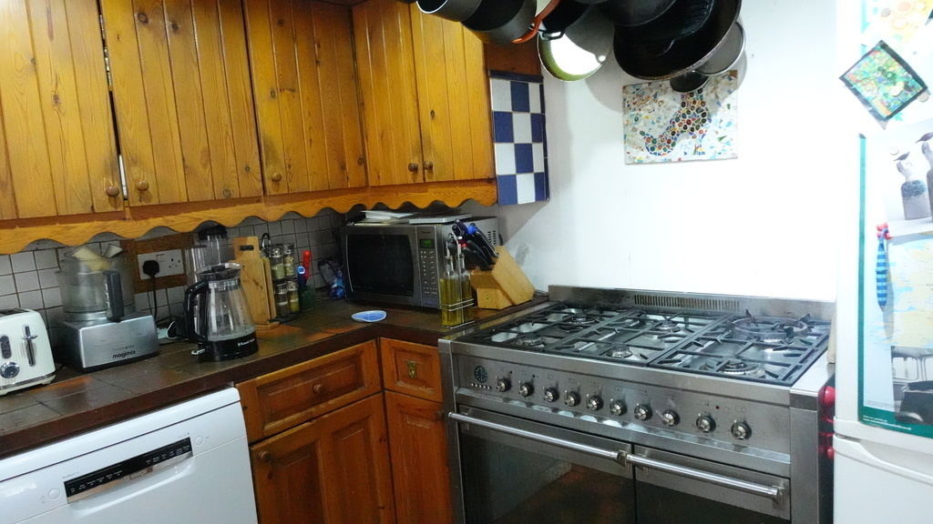 Kitchen - Gas cooker with wok burner and two electric ovens and fridge freezer