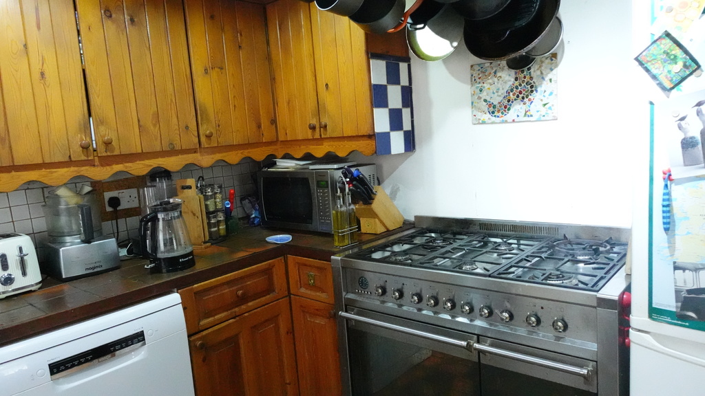 Kitchen - Gas cooker with wok burner and two electric ovens and fridge freezer