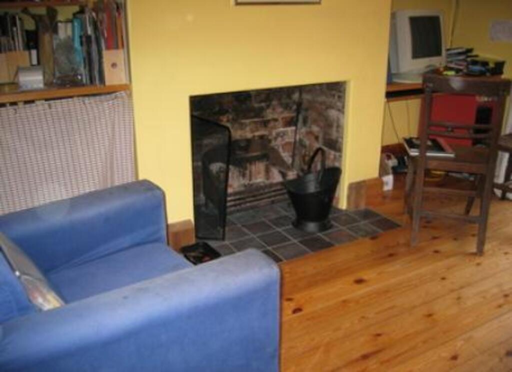 The back room with computer and log fire