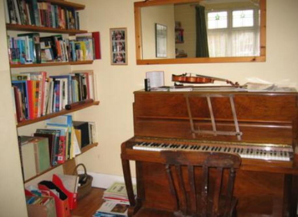 Front room with piano and wood burning stove for winter