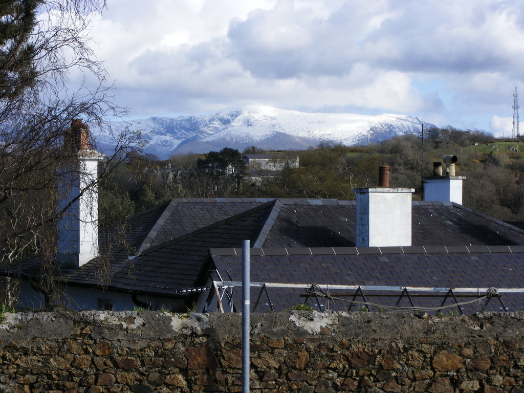 View of house roof and mountains beyond