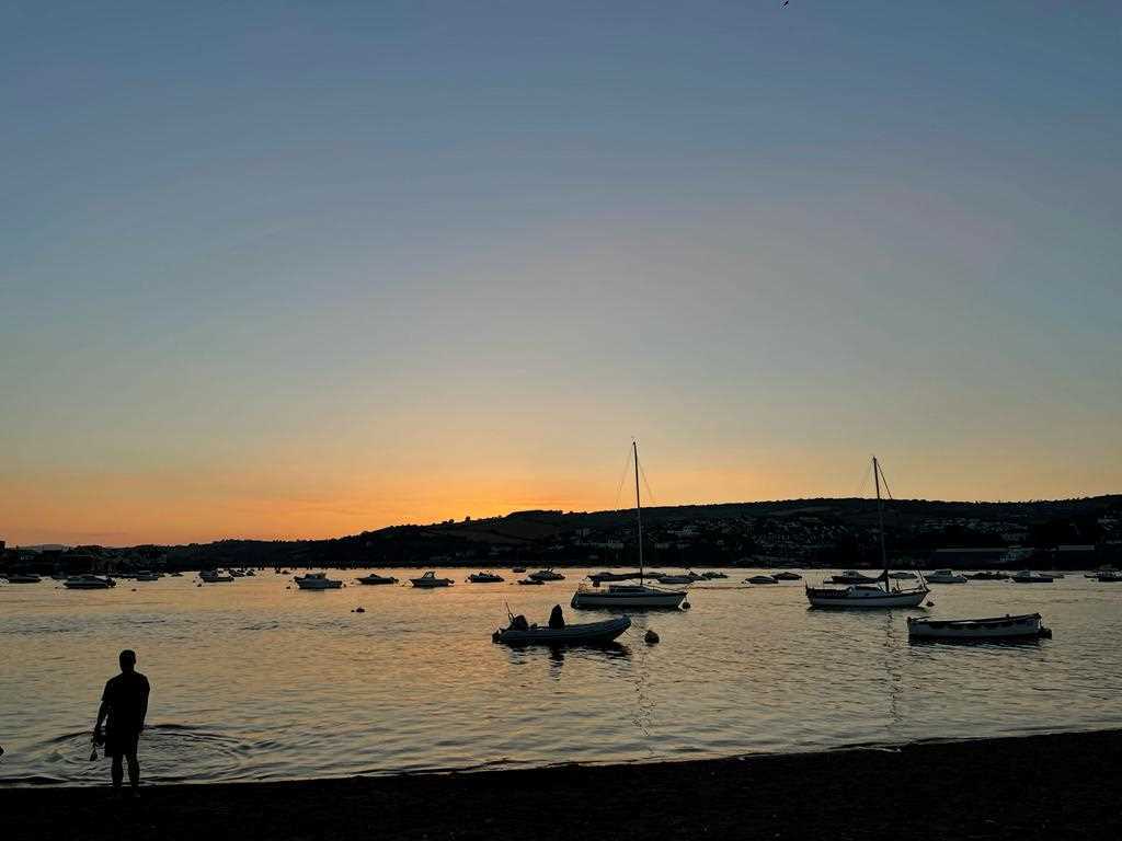 Sunset from Teignmouth's back beach, looking up the River Teign towards Dartmoor 