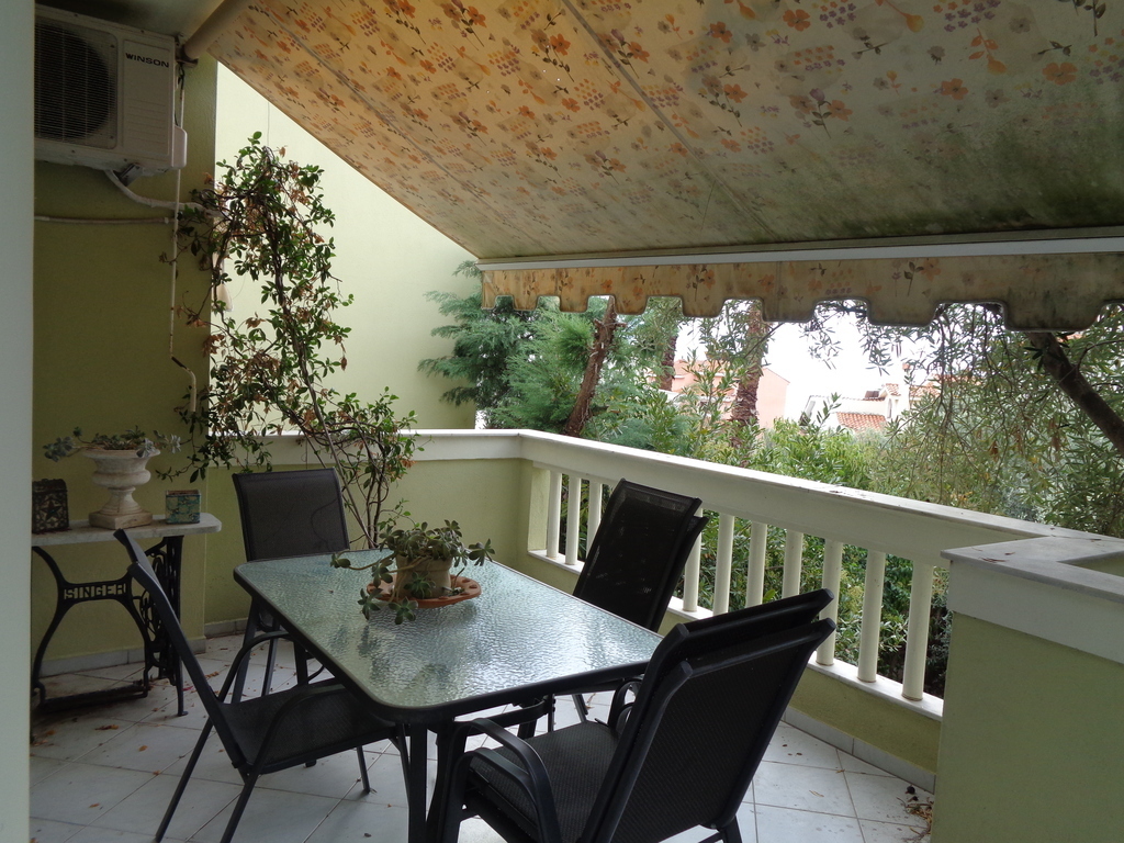table and awnings in middle foor's balcony...dinners or meals  at close-by bbq