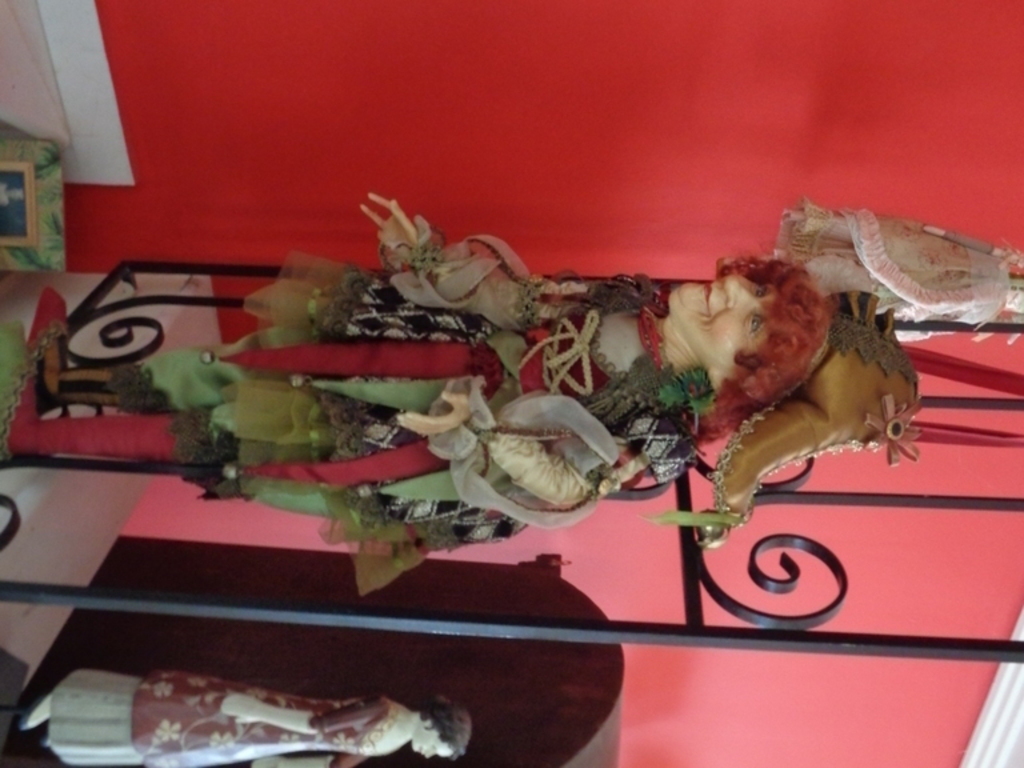 artfull doll hung  by staircase rail