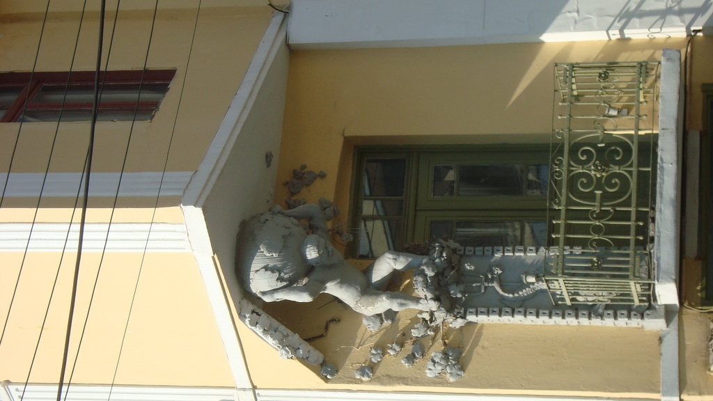 ATLAS, the   mythical  giant..carrying  the  house  on  his   shoulders