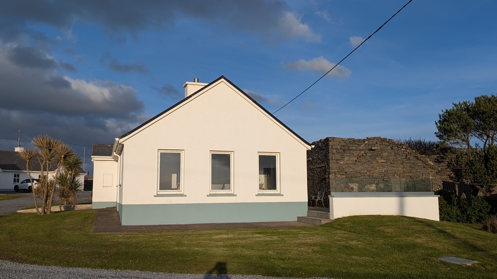 Windows of sitting/dining area with terrace/patio to right