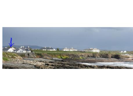 view of cottage (to the left) including seafront to the right