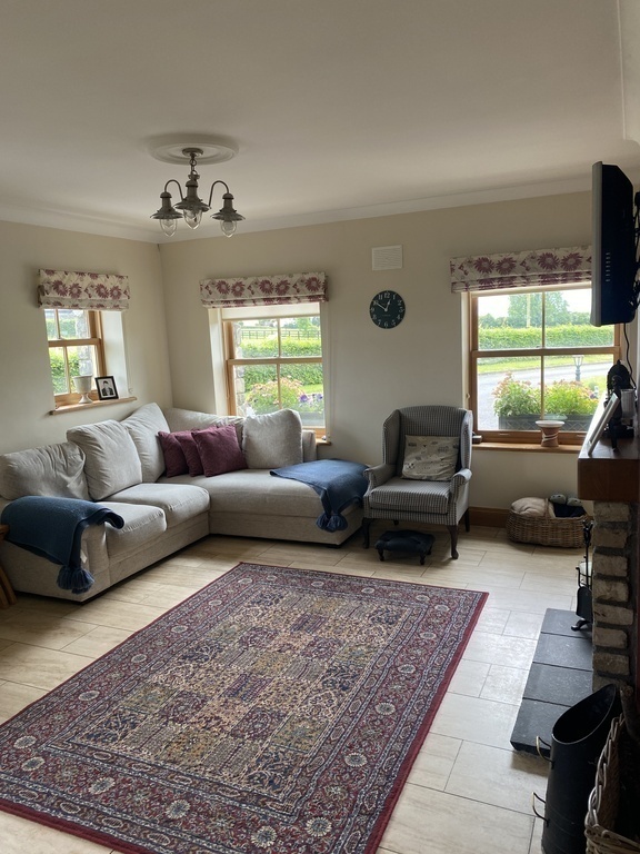living room off kitchen with television