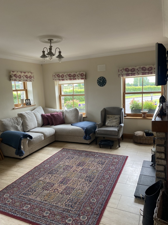 living room off kitchen with television