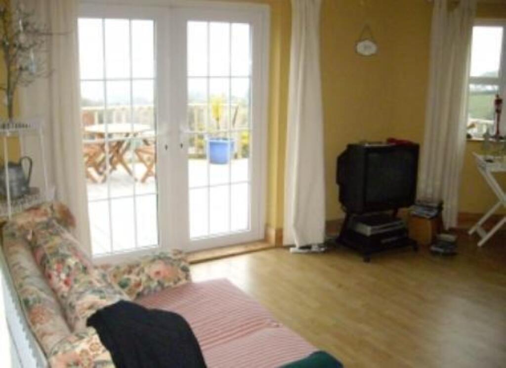 French doors leading from the sun-room onto the deck at the cottage.