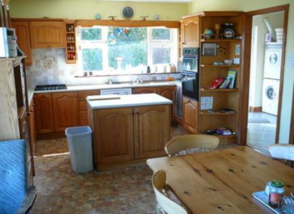 Dining room and kitchen. Window here faces the sun and looks over the patio. Your kids will be safe. 