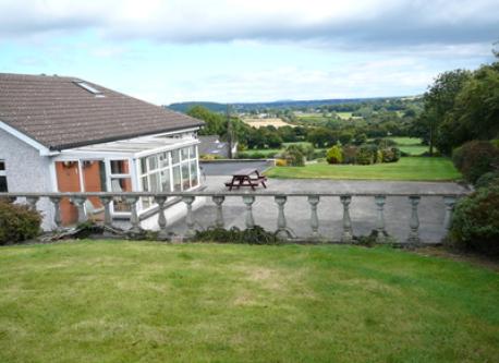The raised garden at rear, overlooking conservatory and patio