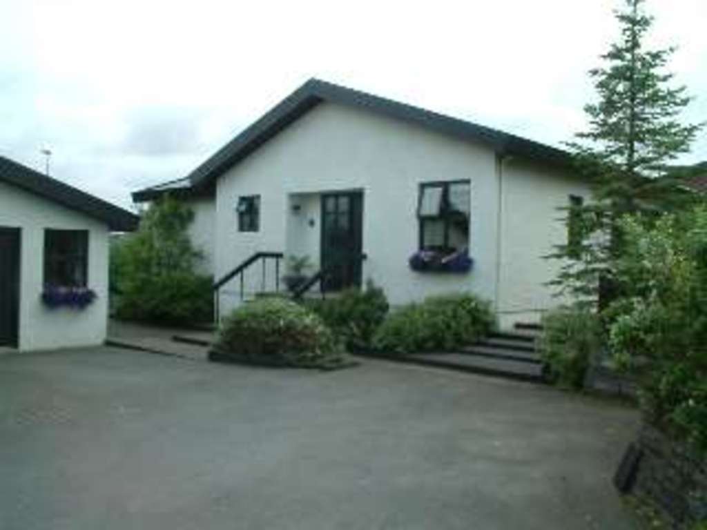 Our house, seen from the street. The garage is on the left.