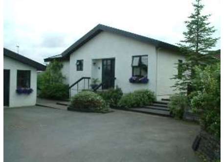 Our house, seen from the street. The garage is on the left.