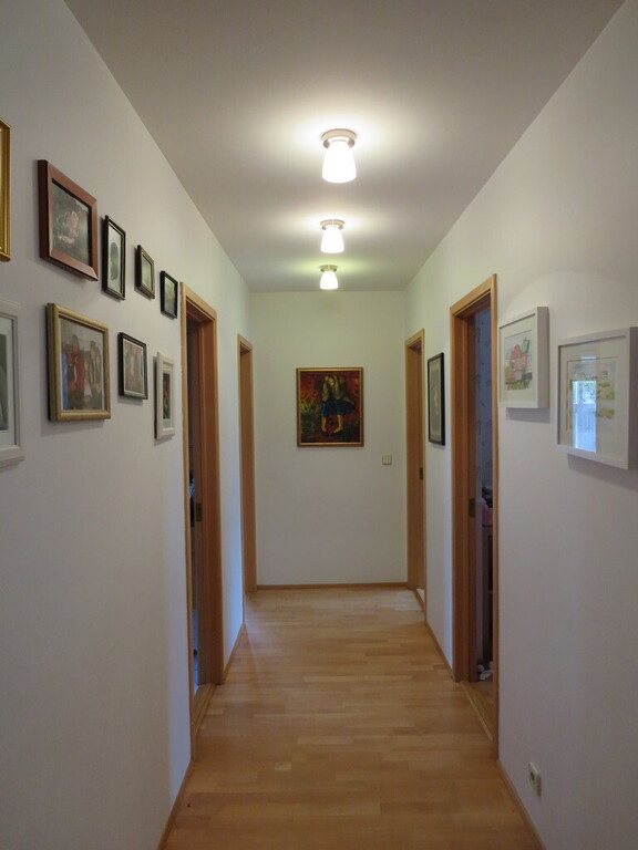 The hallway. There are two bedrooms to the right and the bathroom and a bedroom to the left.
