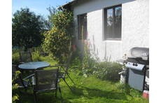 The barbecue and sitting area behind the house. 
