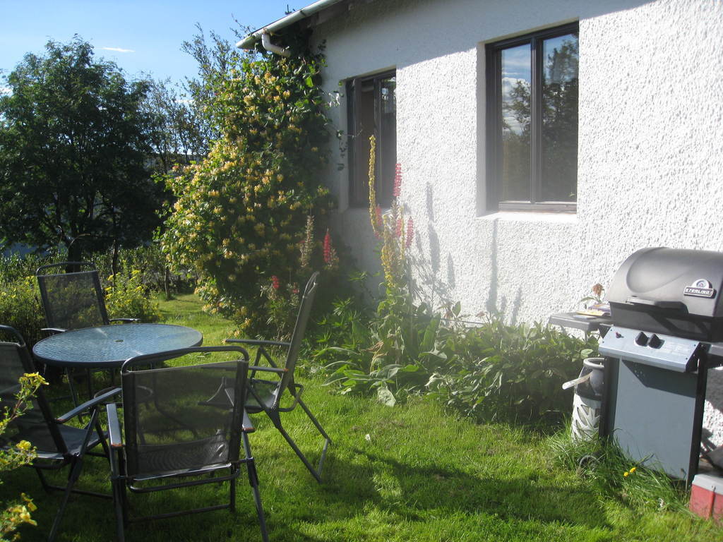 The barbecue and sitting area behind the house. 

