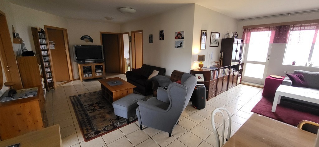 TV area and living room, seen from the kitchen.