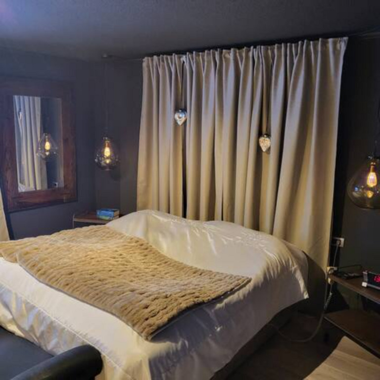 Master bedroom at ground floor with King Size bed and TV