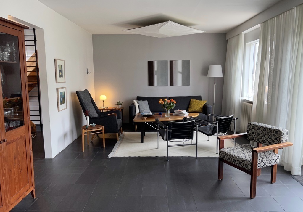 Our living room is on the main floor with doors to the garden, and a patio with furniture, heater and barbecue