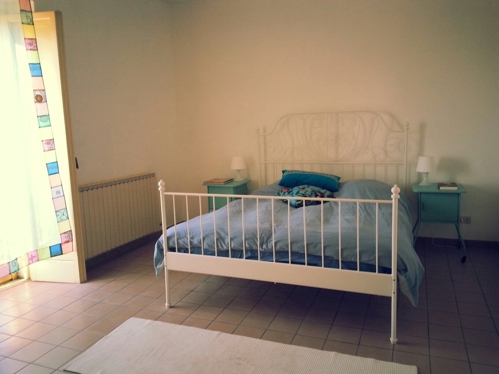 Double bedroom with small balcony views of mountain and sea