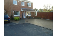 Parking area with house to the left