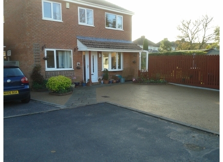 Parking area with house to the left