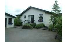 Our house, seen from the street. The garage is on the left.