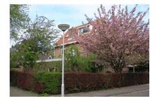 The house in spring, on a corner in a quiet neighbourhood near the town centre, the beach  and a large grassy play field.