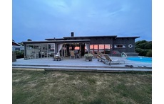 House and poolside at sunset