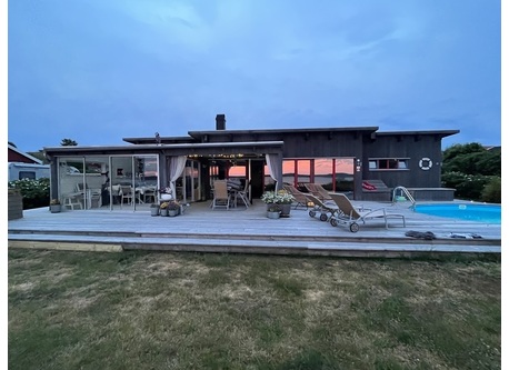 House and poolside at sunset